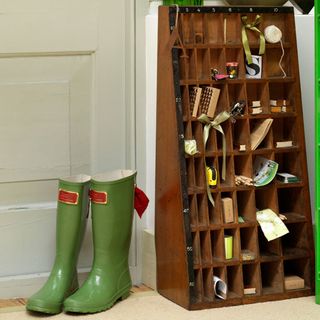 small rack with shoes and door behind