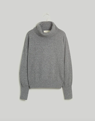 a gray oversize sweater on a hanger
