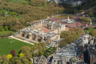 Aerial view of Buckingham Palace, the garden, the Victoria memorial and Green Park in the background.