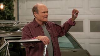 Red Forman holding up car keys while standing next to Vista Cruiser