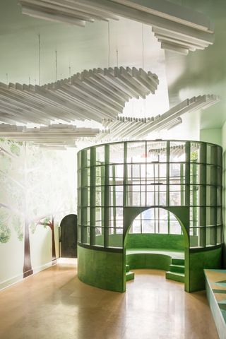 Large circular shaped green wooden seating tower