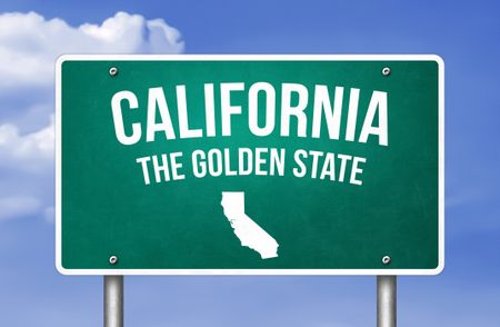 California Road sign with the state name and "The Golden State" against a blue sky 