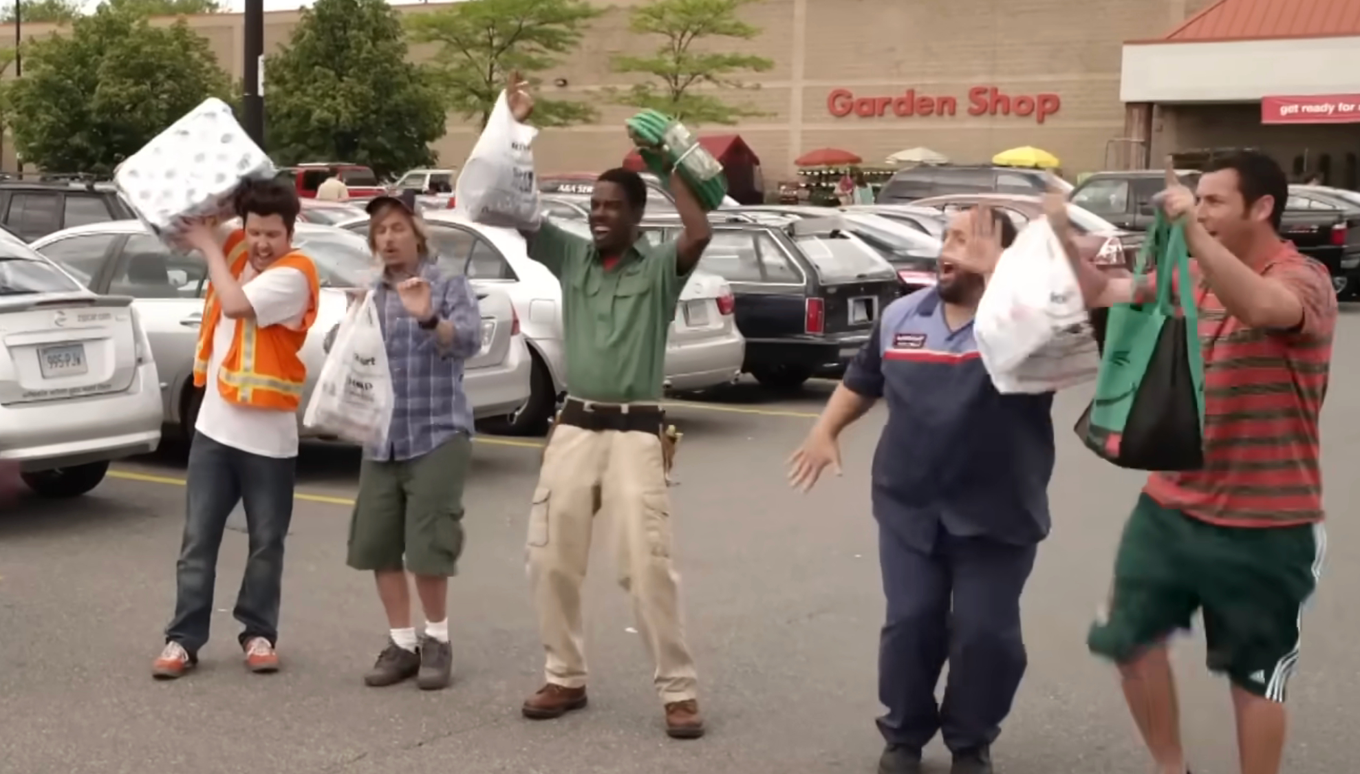Nick Swardson, David Spade, Chris Rock, Adam Sandler and Kevin James dance as they walk out of a KMart.