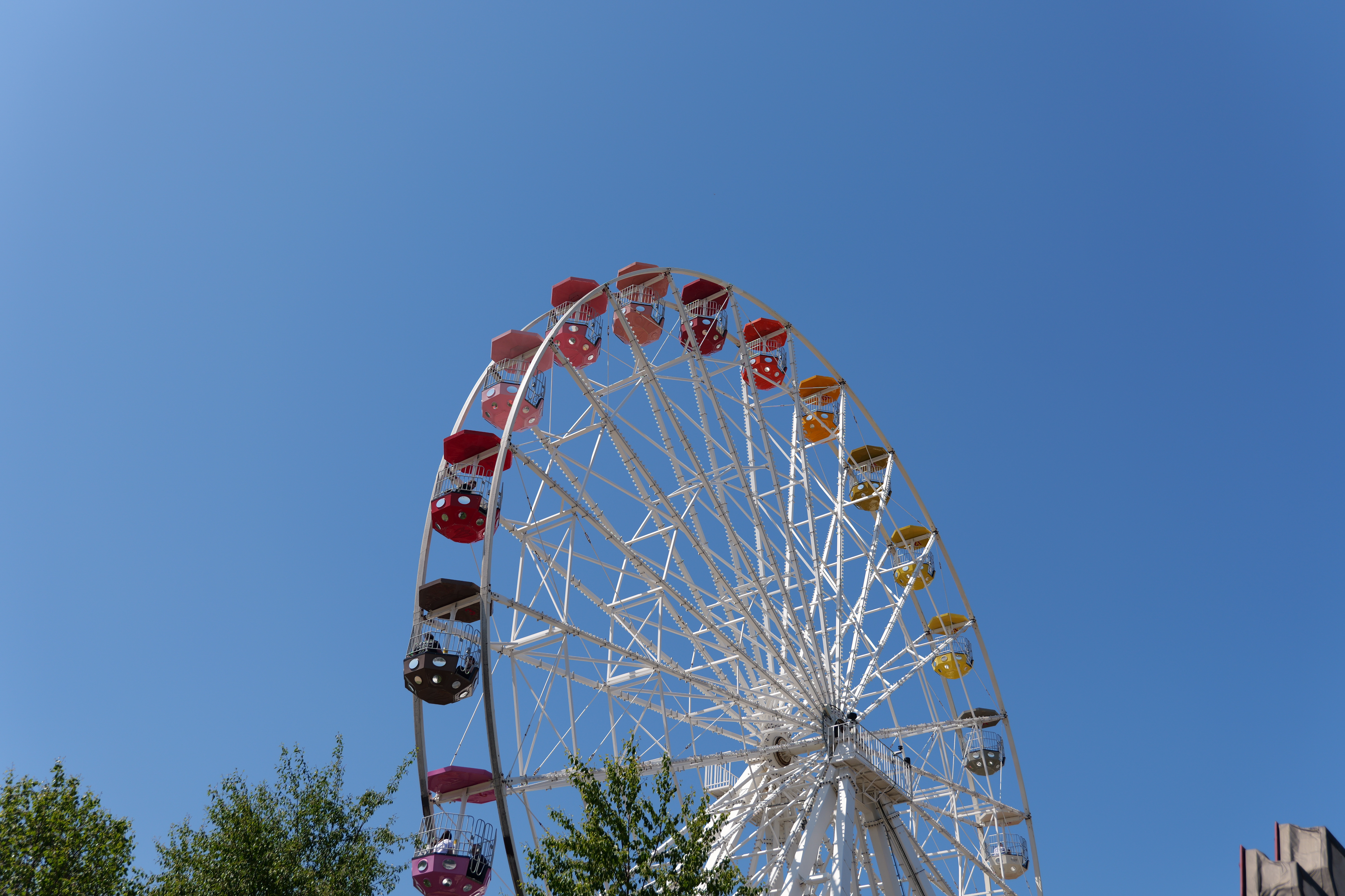 The top of a brightly coloured Ferris wheel