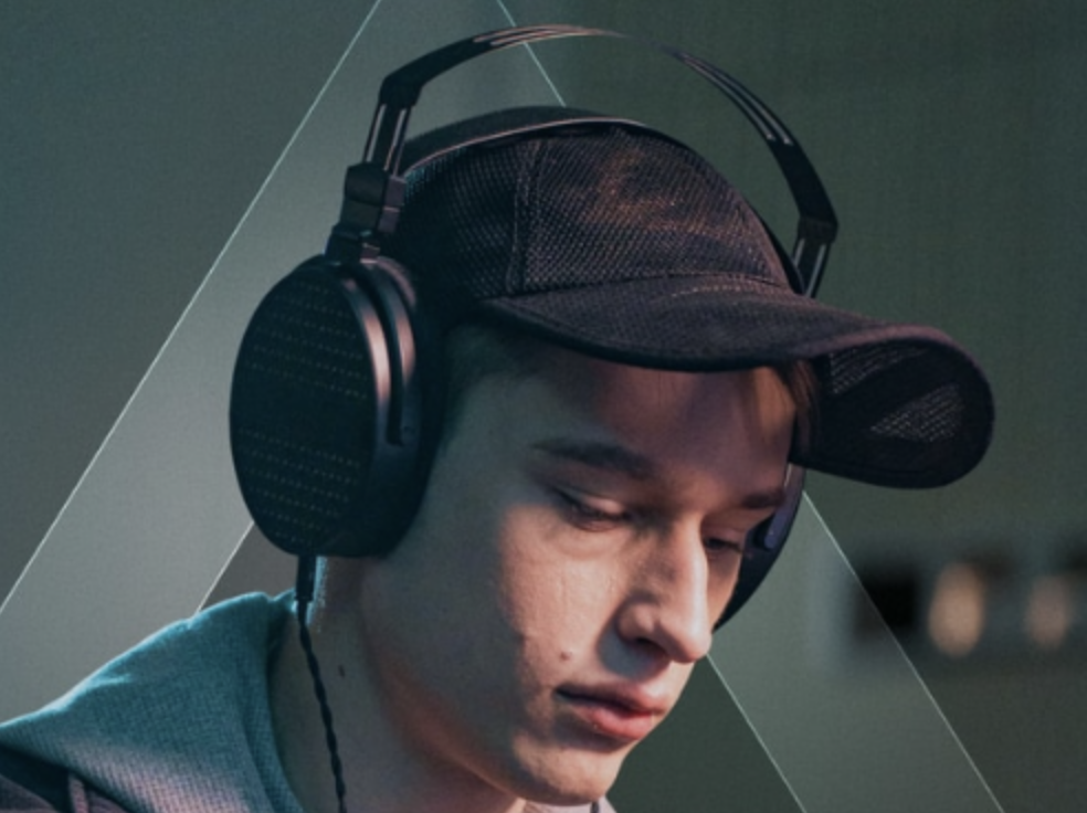 Man wearing cap and ThieAudio Cypher headphones