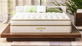 Best mattress for side sleepers: The Saatva Classic mattress shown on a light wooden bed frame in a stylish bedroom