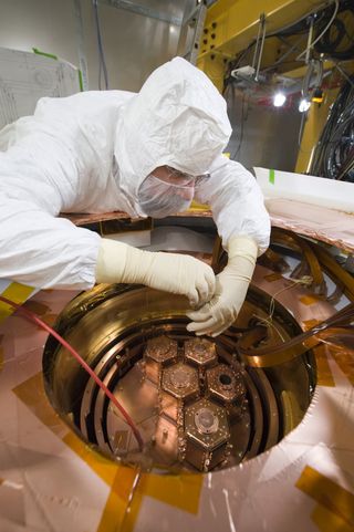 At Fermilab, the Cryogenic Dark Matter Search uses towers of disks made from silicon and germanium to search for particle interactions from dark matter.