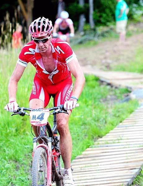 Todd Wells (Specialized) crosses a bog on a wooden bridge.