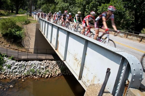 The bunch passes over the river cutting through town.