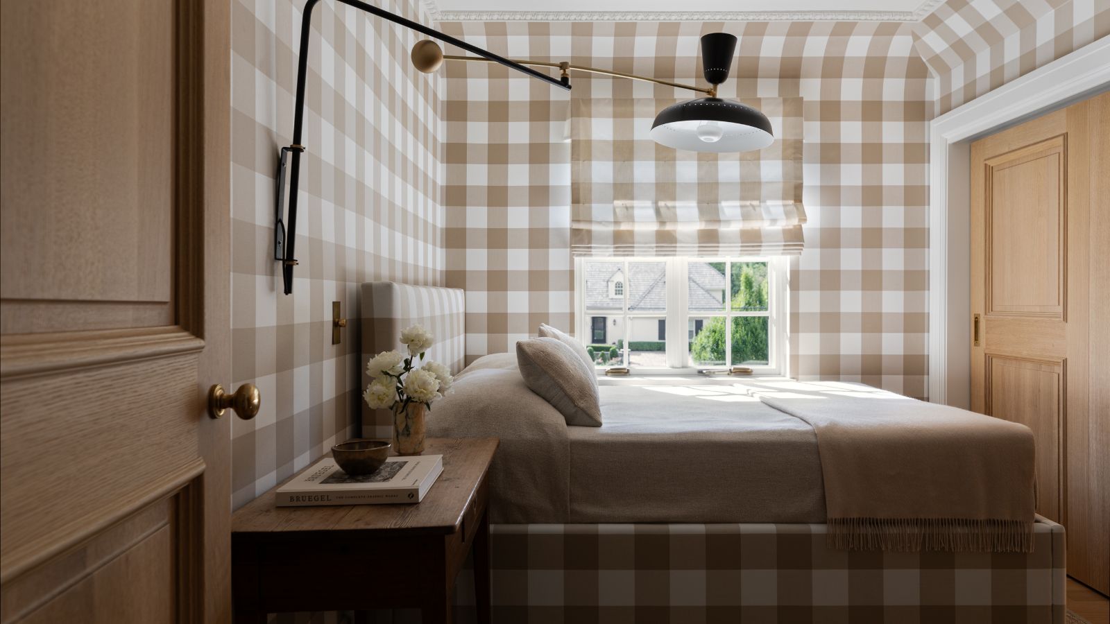small pattern drenched bedroom with matching beige gingham walls, bed upholstery and window blind 