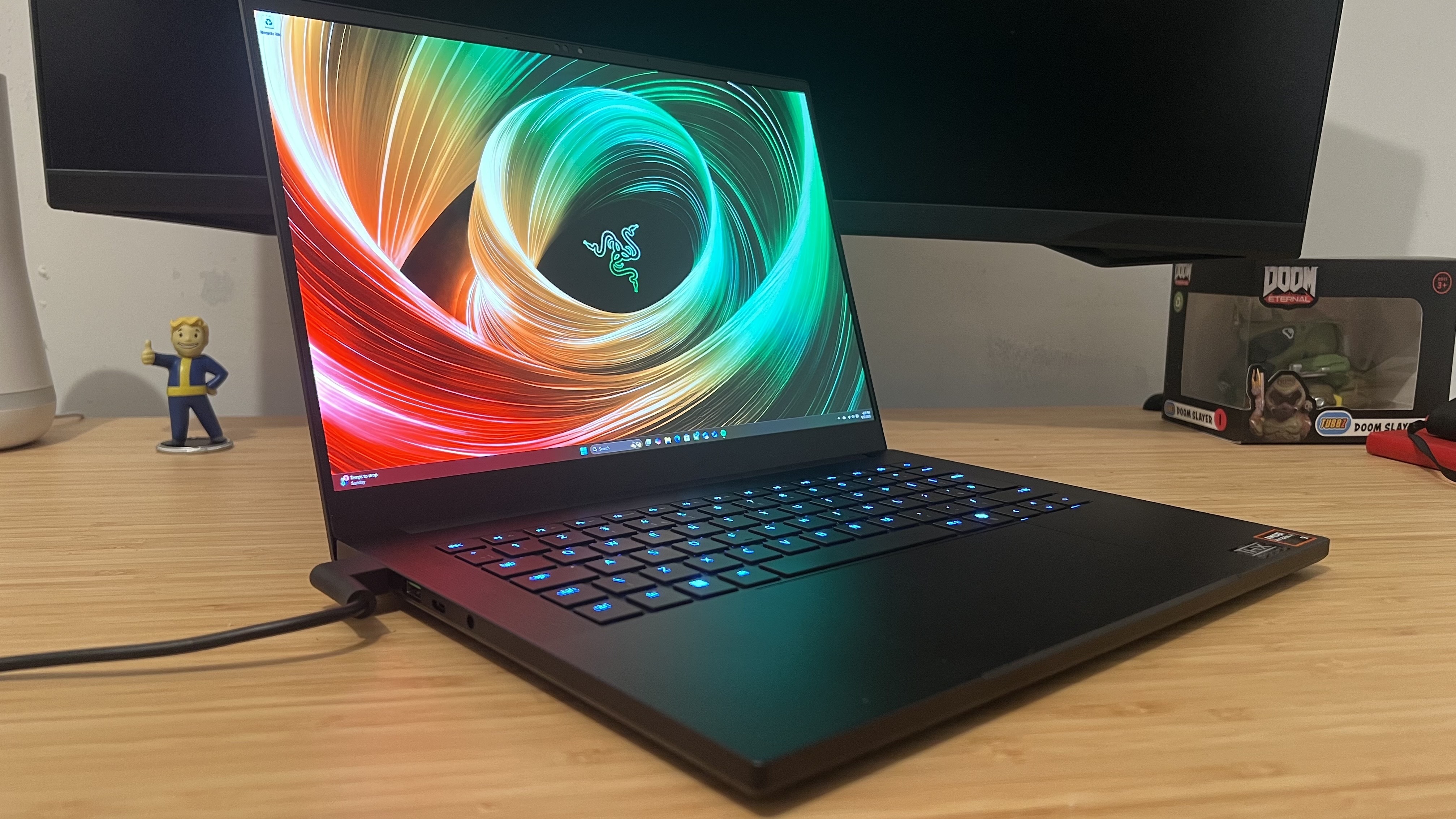 Razer Blade 14 gaming laptop open on a wooden desk