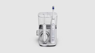 Image shows the Waterpik Complete Care 9.0 electric toothbrush and flosser against a white background.