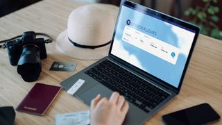 A laptop open on a flight price comparison website.