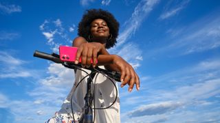 a woman sat smiling on an e-bike