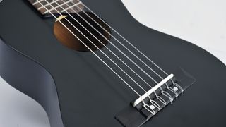 Yamaha GL-1 Guitalele review: Close up of a black Yamaha GL-1 Guitalele on a white/grey background