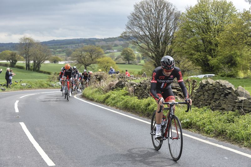 An NFTO rider gets clear from the peloton