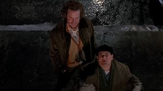 Harry and Marv looking up to the rooftop of a brownstone in Home Alone 2: Lost in New York.