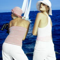 two women on a sailboat wearing nautical clothes