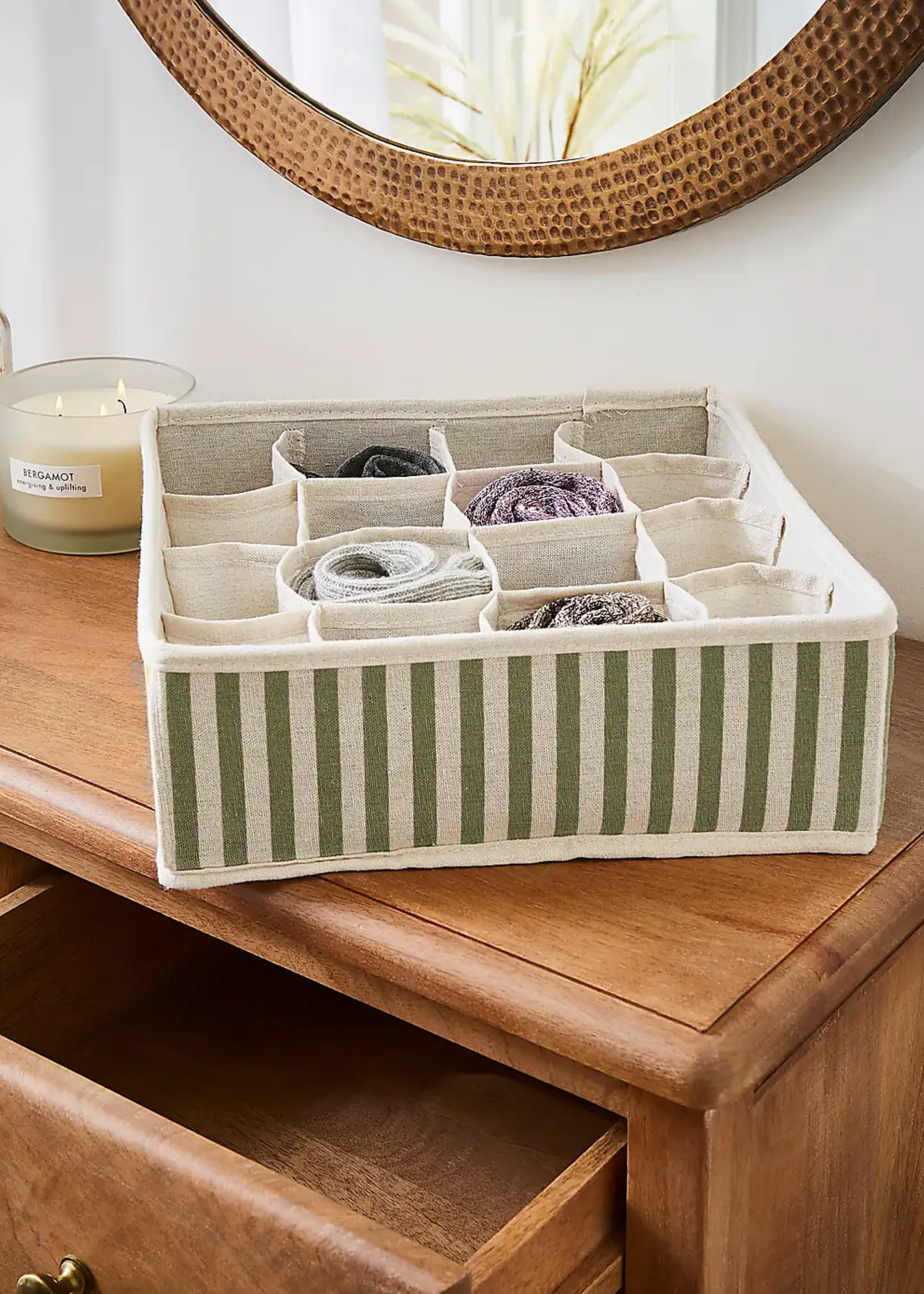 A striped green storage box with compartments from Dunelm