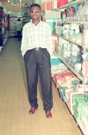 Well dressed African male standing in supermarket