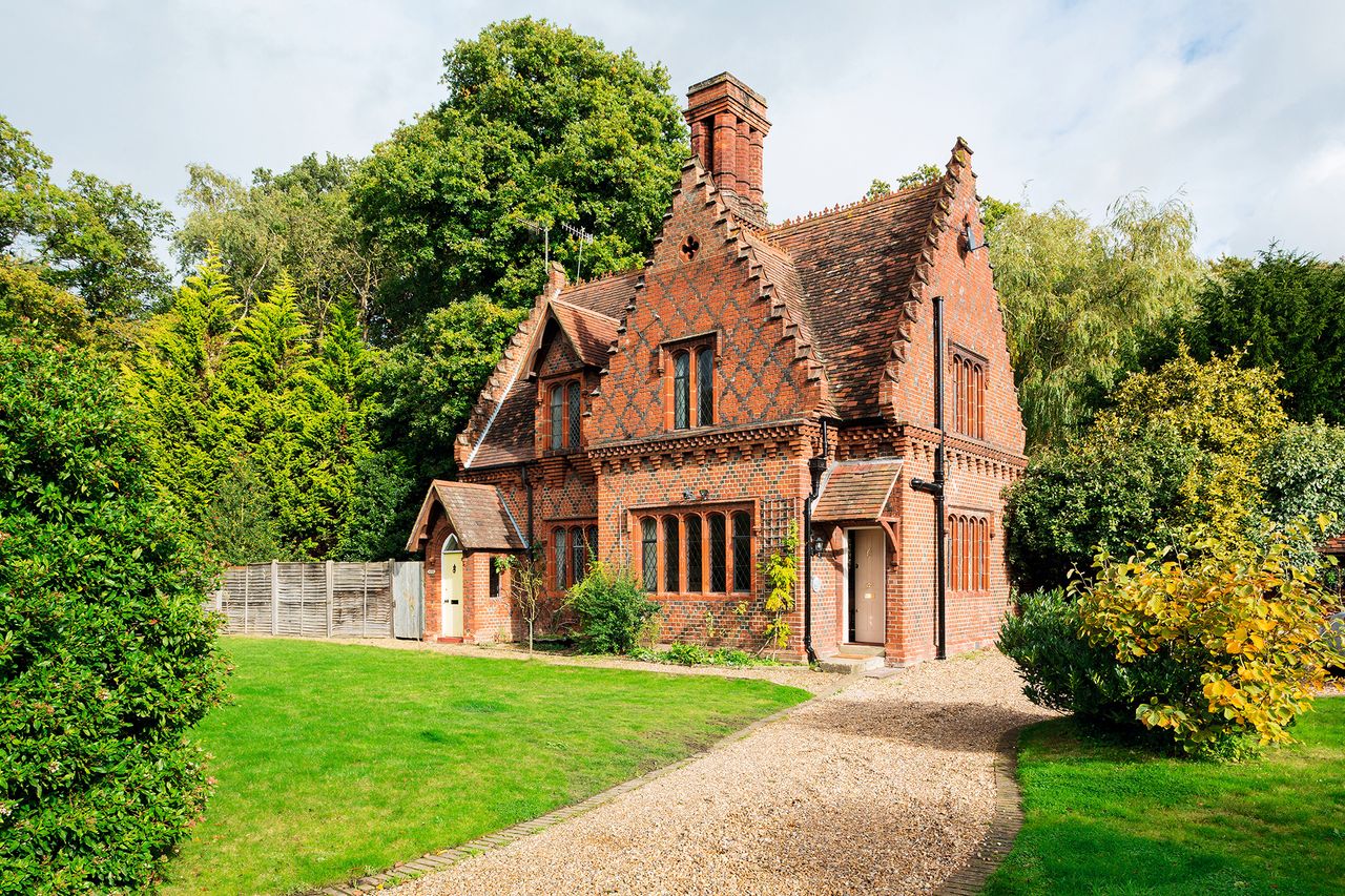 red brick gothic revival house style with front garden