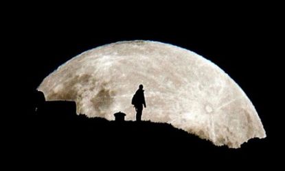A person is silhouetted against the rising super moon in New Zealand on May 6