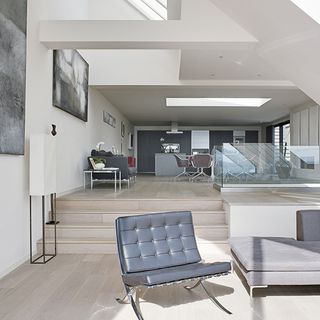 open plan living area with chair and stairs