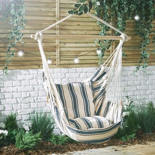 hanging rope chair with blue and white stripes and wooden detailing