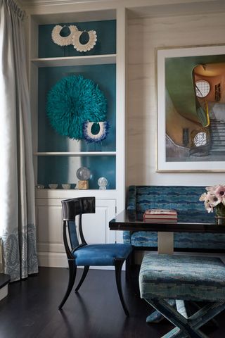 blue dining room with decor on shelves
