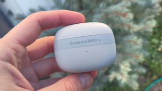 Bowers & Wilkins Pi6 wireless in-ears charging case held in hand