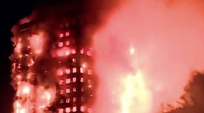 An apartment tower burns in London