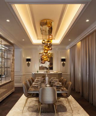 A bespoke gold chandelier in an ornate dining room