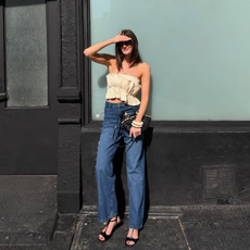 An image of a woman wearing jeans and strapless top, the best summer denim outfit inspiration 2026.