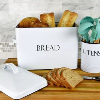 The Outshine Co Extra Large Bread Box on a wooden cutting board, with slices of bread