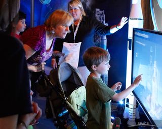 Children explore the interactive exhibits at the Intrepid Museum's SpaceFest, which ran from July 25 to July 28, 2013.