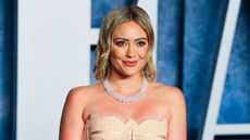 hilary duff on a blue and white background