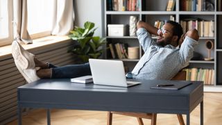 Man with laptop taking a break from work