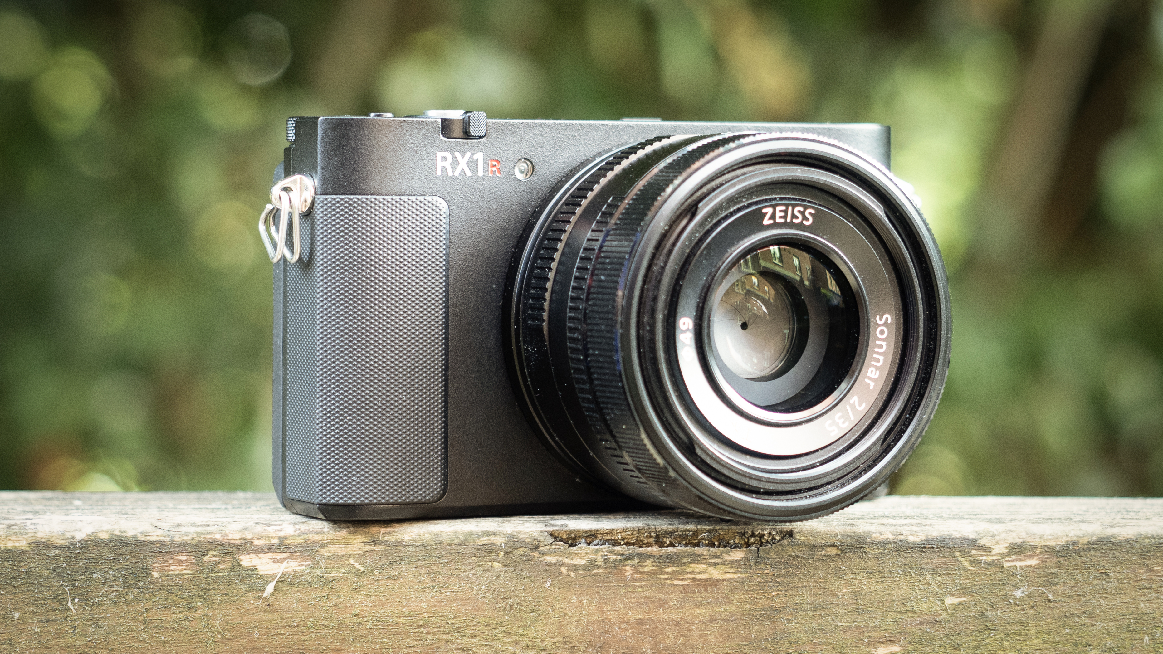 Sony RX1R III on a wooden surface in a woodland environment
