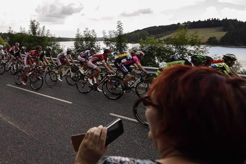 A spectator captures the action during stage 14.