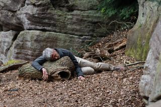 Caleb in Emmerdale lying at the bottom of a cliff with blood on his head