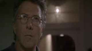 Close up of Dustin Hoffman looking interested, wearing glasses