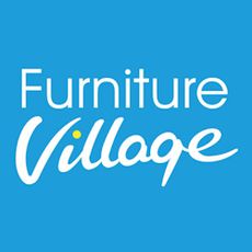 A modern, green lounge with dark, velvet sofas, a round, rattan and wooden coffee table, and various accessories, all from Furniture Village. 