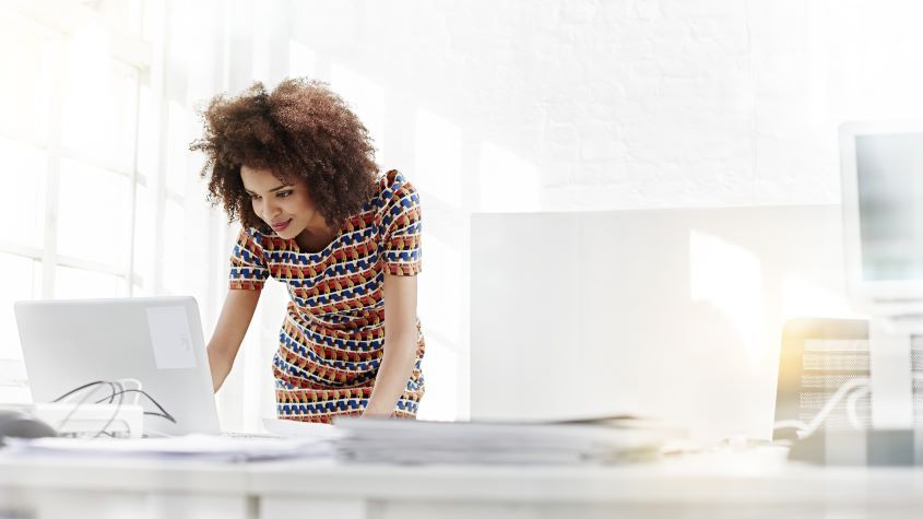 Woman working on a laptop in an office