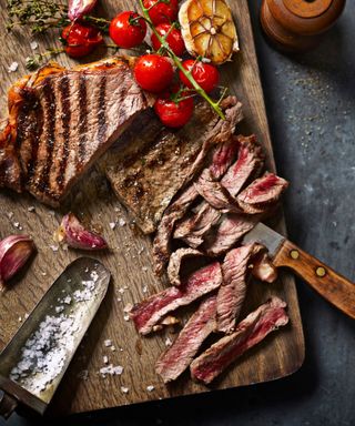 Steak sliced thinly on a chopping board