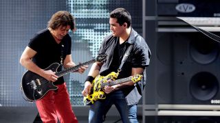 Musicians Eddie Van Halen (L) and Wolfgang Van Halen of Van Halen perform at their dress rehearsal for family and friends at the Forum on February 8, 2012 in Inglewood, California. 