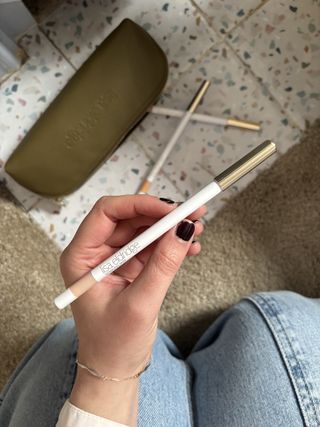 Mica Ricketts holding Lisa Eldridge Pinpoint Concealer Micro Correcting Pencil in hands