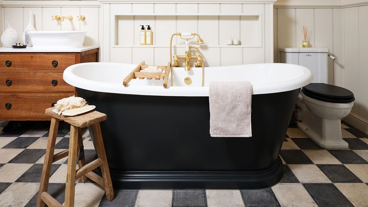 Bathroom with black bath and checkered flooring