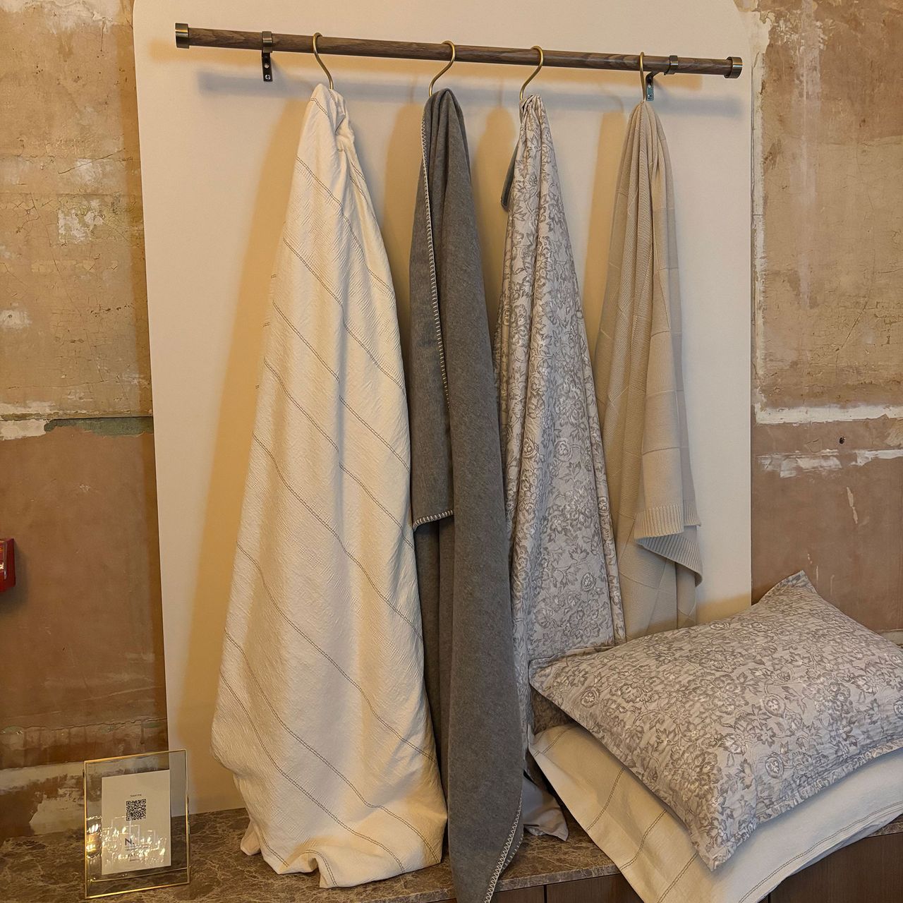 Next homeware bedding and blankets hung from a rail