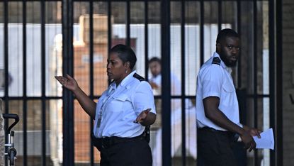 Guards in front of bars at Wandsworth Prison, south London