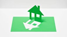 A house silhouette cut out from a sheet of green paper
